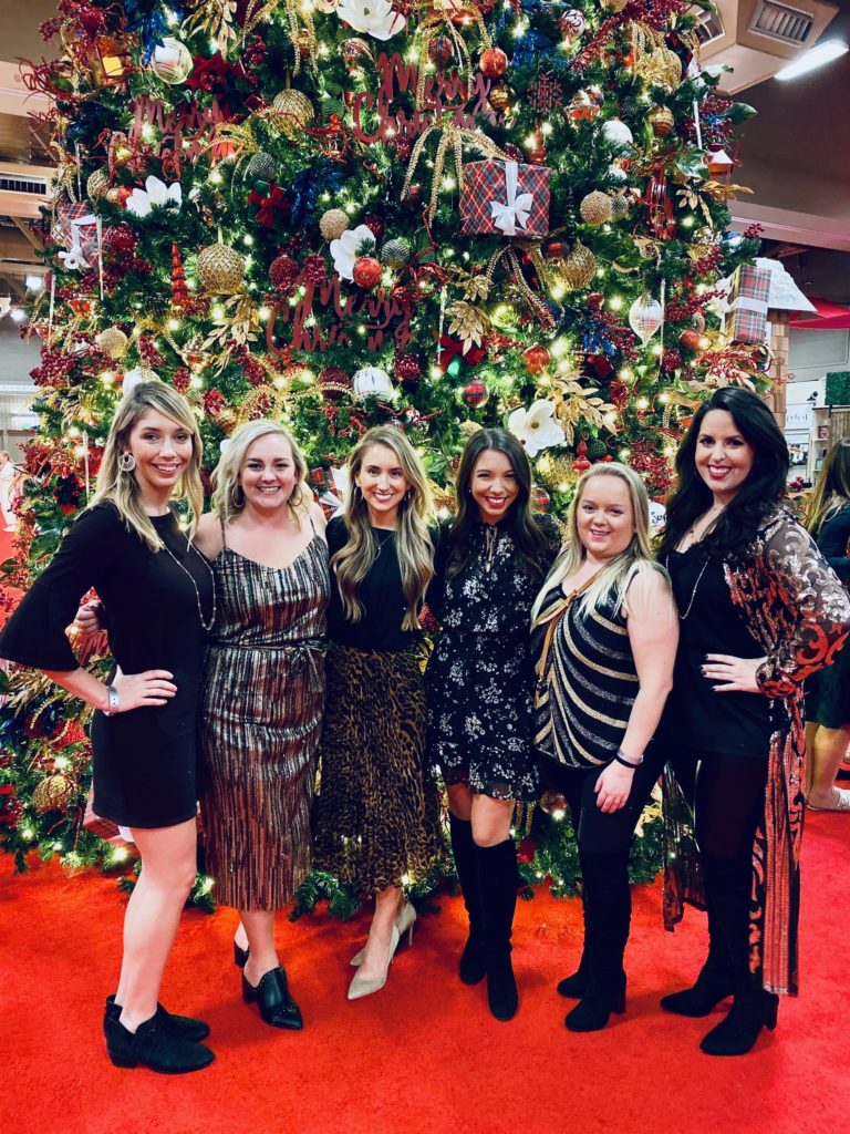 Junior League Friends Posing for Photo in Front of Christmas Tree at A Christmas Affair