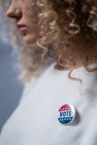 Female Voter with "Vote" Pin